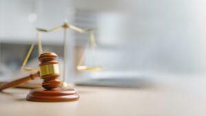 A gavel on a table. Accepting or rejecting a car accident settlement.