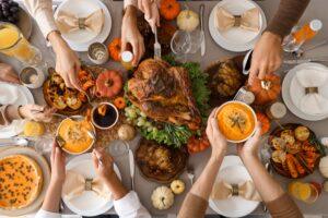 Happy family having dinner at festive table on Thanksgiving Day, top view.