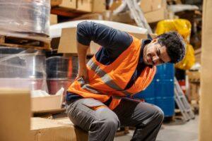 An injured worker holding his back. What is the waiting period for workers' compensation in North Carolina?